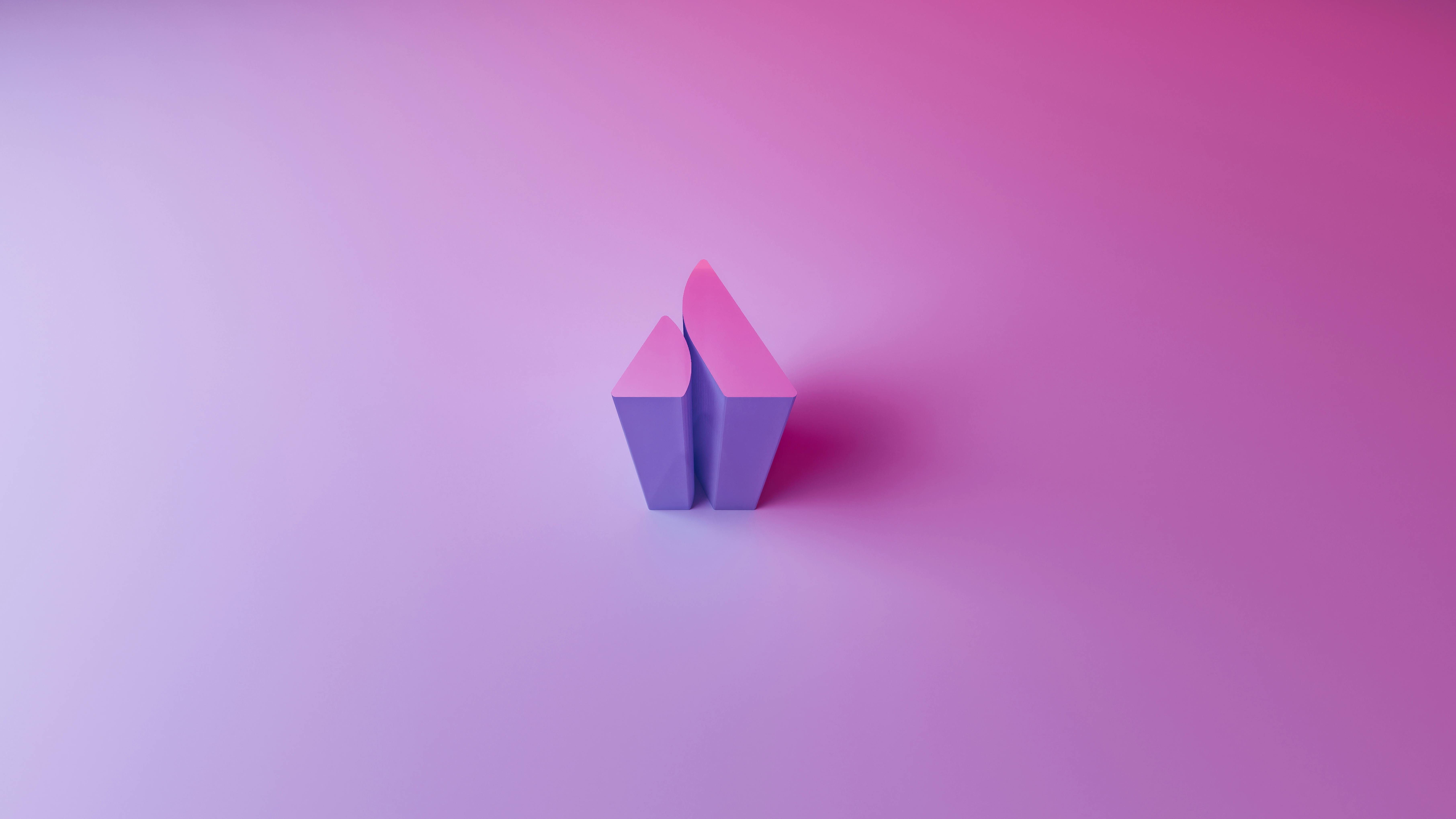 Abstract geometric shapes on a gradient pink and violet background with ample copy space.